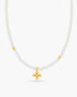 Necklace with white beads and a gold cross pendant on a white background